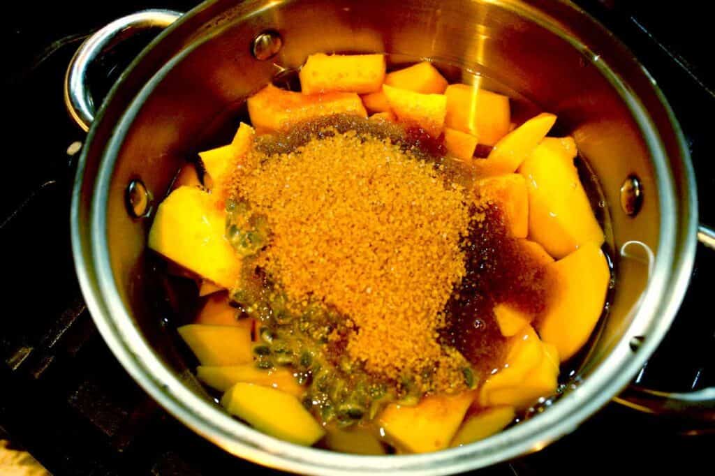 Adding brown sugar to mangoes and passionfruit