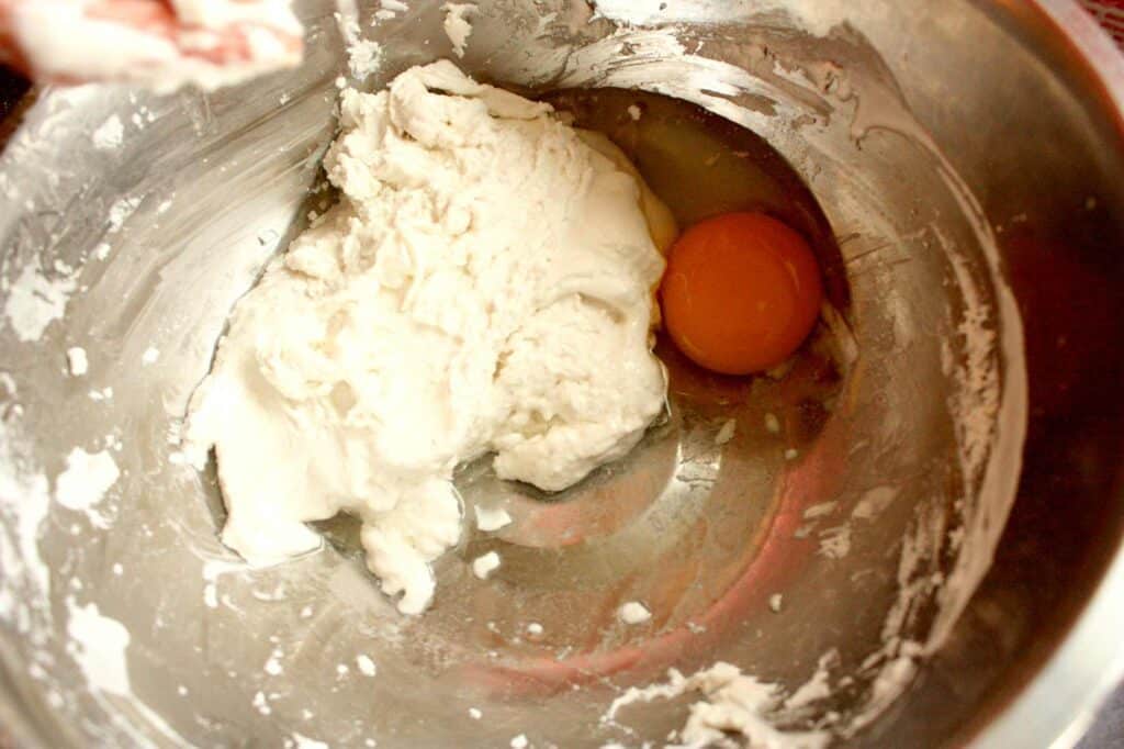 adding egg to the pancake batter