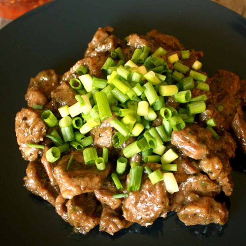 Pork cheeks served with green onions, chilli sauce, and Cambodian dipping sauce